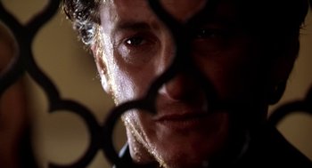 Movie still from “U Turn” (1997), directed by Oliver Stone – A man's face through a pair of scissors; Extreme Close Up shot, Low angle