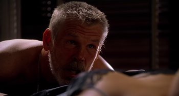 Movie still from “U Turn” (1997), directed by Oliver Stone – An older man is looking at the camera; Close Up shot, Over the shoulder angle