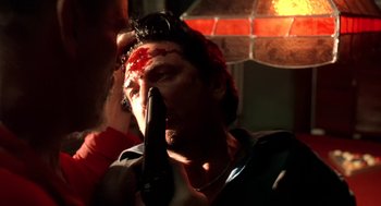 Movie still from “U Turn” (1997), directed by Oliver Stone – A man with a knife in his mouth; Close Up shot, Low angle