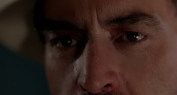 Movie still from “U Turn” (1997), directed by Oliver Stone – A man's eyes and face; Extreme Close Up shot, Low angle