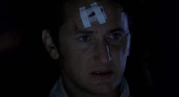 Movie still from “U Turn” (1997), directed by Oliver Stone – A man with bandages on his head and face; Close Up shot, Low angle