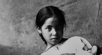 Movie still from “U Turn” (1997), directed by Oliver Stone – An old photo of a young girl with a cross on her chest; Extreme Close Up shot, Low angle