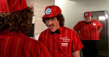 Movie still from “UHF” (1989), directed by Jay Levey – A man in a red and white striped shirt and hat; Medium shot, Over the shoulder angle