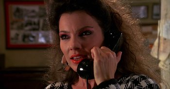 Movie still from “UHF” (1989), directed by Jay Levey – A person talking on a phone; Close Up shot, High angle