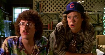 Movie still from “UHF” (1989), directed by Jay Levey – Two people sitting next to each other in a room; Close Up shot, Low angle