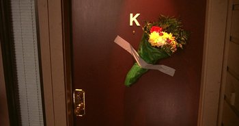 Movie still from “UHF” (1989), directed by Jay Levey – A bouquet of flowers hanging on the wall of a room; Extreme Close Up shot, High angle