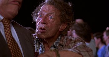 Movie still from “UHF” (1989), directed by Jay Levey – An old man with a very big face; Close Up shot, Low angle