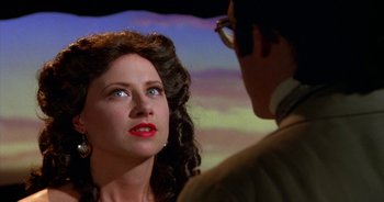 Movie still from “UHF” (1989), directed by Jay Levey – A man and a woman looking at one another; Close Up shot, Over the shoulder angle