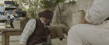 Movie still from “Udta Punjab” (2016), directed by Abhishek Chaubey – A man with a blindfold on his head; Medium shot, Over the shoulder angle