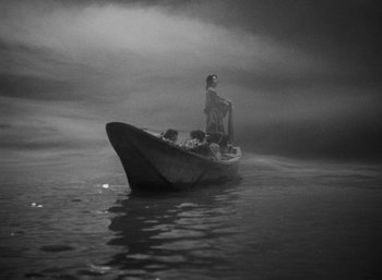 A person in a boat in the middle of a body of water