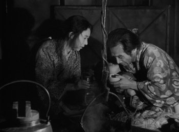 A man and a woman are looking at a phone