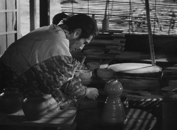 A person is working on a pottery wheel