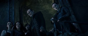 Movie still from “Underworld: Rise of the Lycans” (2009), directed by Patrick Tatopoulos – A group of people standing next to each other in a room; Medium shot, Low angle