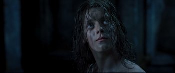 Movie still from “Underworld: Rise of the Lycans” (2009), directed by Patrick Tatopoulos – A young woman with wet hair and blue eyes; Close Up shot, Low angle