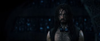 Movie still from “Underworld: Rise of the Lycans” (2009), directed by Patrick Tatopoulos – A man with long black hair and a bow tie; Close Up shot, Over the shoulder angle