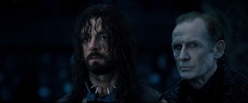 Movie still from “Underworld: Rise of the Lycans” (2009), directed by Patrick Tatopoulos – A person with long hair; Close Up shot, Over the shoulder angle