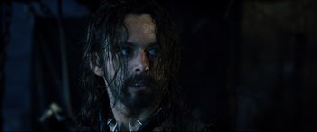 Movie still from “Underworld: Rise of the Lycans” (2009), directed by Patrick Tatopoulos – A person with long hair and a beard; Close Up shot, Over the shoulder angle
