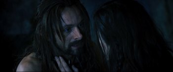 Movie still from “Underworld: Rise of the Lycans” (2009), directed by Patrick Tatopoulos – A man with long hair and blue eyes looking at a woman with long black hair; Close Up shot, Over the shoulder angle