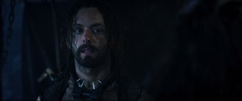 Movie still from “Underworld: Rise of the Lycans” (2009), directed by Patrick Tatopoulos – A person with long hair and a beard; Close Up shot, Over the shoulder angle