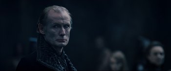 Movie still from “Underworld: Rise of the Lycans” (2009), directed by Patrick Tatopoulos – An older man is looking into the distance; Close Up shot, Over the shoulder angle