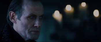 Movie still from “Underworld: Rise of the Lycans” (2009), directed by Patrick Tatopoulos – A person's face with lights in the background; Close Up shot, Low angle
