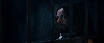 Movie still from “Underworld: Rise of the Lycans” (2009), directed by Patrick Tatopoulos – A person looking out of a jail cell; Close Up shot, Over the shoulder angle