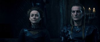 Movie still from “Underworld: Rise of the Lycans” (2009), directed by Patrick Tatopoulos – A woman and a man are standing next to each other; Medium shot, Over the shoulder angle