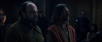 Movie still from “Underworld: Rise of the Lycans” (2009), directed by Patrick Tatopoulos – Two men standing next to each other in front of a wall; Medium shot, Over the shoulder angle