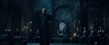 Movie still from “Underworld: Rise of the Lycans” (2009), directed by Patrick Tatopoulos – A man in a black suit and a woman in a black dress; Wide shot, Low angle