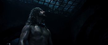 Movie still from “Underworld: Rise of the Lycans” (2009), directed by Patrick Tatopoulos – A man with long hair is standing in a dark room; Medium shot, Low angle