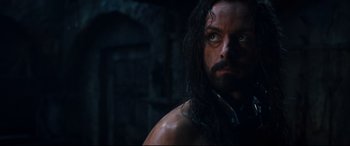 Movie still from “Underworld: Rise of the Lycans” (2009), directed by Patrick Tatopoulos – A person with long hair and a beard; Close Up shot, High angle