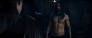 Movie still from “Underworld: Rise of the Lycans” (2009), directed by Patrick Tatopoulos – A man with long hair and a beard standing in front of a mirror; Medium shot, Over the shoulder angle