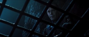 Movie still from “Underworld: Rise of the Lycans” (2009), directed by Patrick Tatopoulos – A man looking through a window at night; Close Up shot, Over the shoulder angle