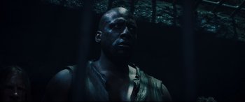 Movie still from “Underworld: Rise of the Lycans” (2009), directed by Patrick Tatopoulos – A man with a beard is standing in a dark room; Close Up shot, Low angle