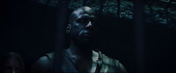 Movie still from “Underworld: Rise of the Lycans” (2009), directed by Patrick Tatopoulos – A man in a dark room looking into the distance; Close Up shot, Low angle