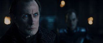 Movie still from “Underworld: Rise of the Lycans” (2009), directed by Patrick Tatopoulos – A person wearing a suit and tie; Close Up shot, Over the shoulder angle