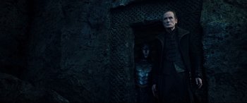 Movie still from “Underworld: Rise of the Lycans” (2009), directed by Patrick Tatopoulos – A man standing next to another man near a wall; Medium shot, Low angle