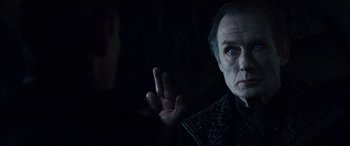 Movie still from “Underworld: Rise of the Lycans” (2009), directed by Patrick Tatopoulos – An older man in a black shirt is looking at the camera; Close Up shot, Over the shoulder angle