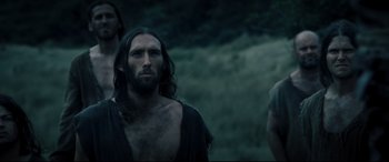 Movie still from “Underworld: Rise of the Lycans” (2009), directed by Patrick Tatopoulos – A man with long hair and a beard standing next to another man with long hair; Medium shot, Low angle