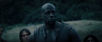 Movie still from “Underworld: Rise of the Lycans” (2009), directed by Patrick Tatopoulos – A man with a bald head is looking at the camera; Close Up shot, Low angle