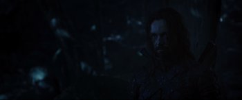 Movie still from “Underworld: Rise of the Lycans” (2009), directed by Patrick Tatopoulos – A person holding a sword in a dark room; Close Up shot, Low angle