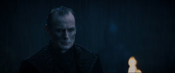 Movie still from “Underworld: Rise of the Lycans” (2009), directed by Patrick Tatopoulos – A person wearing a suit and tie; Close Up shot, Low angle