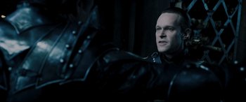 Movie still from “Underworld: Rise of the Lycans” (2009), directed by Patrick Tatopoulos – A man in a leather jacket is sitting in a dark room; Close Up shot, Over the shoulder angle