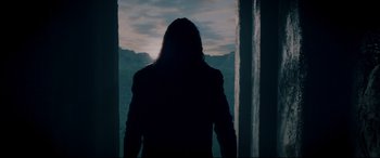 Movie still from “Underworld: Rise of the Lycans” (2009), directed by Patrick Tatopoulos – A person standing in front of a window with mountains in the background; Medium shot, Low angle