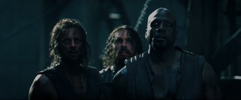 Movie still from “Underworld: Rise of the Lycans” (2009), directed by Patrick Tatopoulos – A group of men standing next to each other in the dark; Close Up shot, Low angle