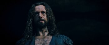 Movie still from “Underworld: Rise of the Lycans” (2009), directed by Patrick Tatopoulos – A person with long hair and a beard; Close Up shot, Low angle