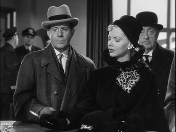 Movie still from “Unfaithfully Yours” (1948), directed by Preston Sturges – A man and a woman are standing next to each other; Medium shot, Low angle