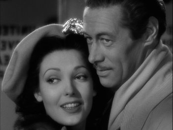 Movie still from “Unfaithfully Yours” (1948), directed by Preston Sturges – A man and a woman posing for a picture; Close Up shot, High angle