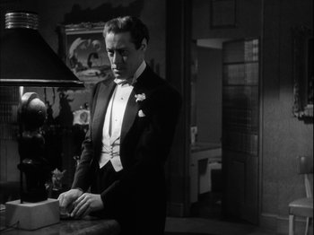 Movie still from “Unfaithfully Yours” (1948), directed by Preston Sturges – A black and white photo of a man in a tuxedo; Medium shot, Over the shoulder angle