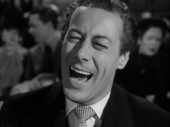 Movie still from “Unfaithfully Yours” (1948), directed by Preston Sturges – A black and white photo of a man laughing; Close Up shot, Low angle